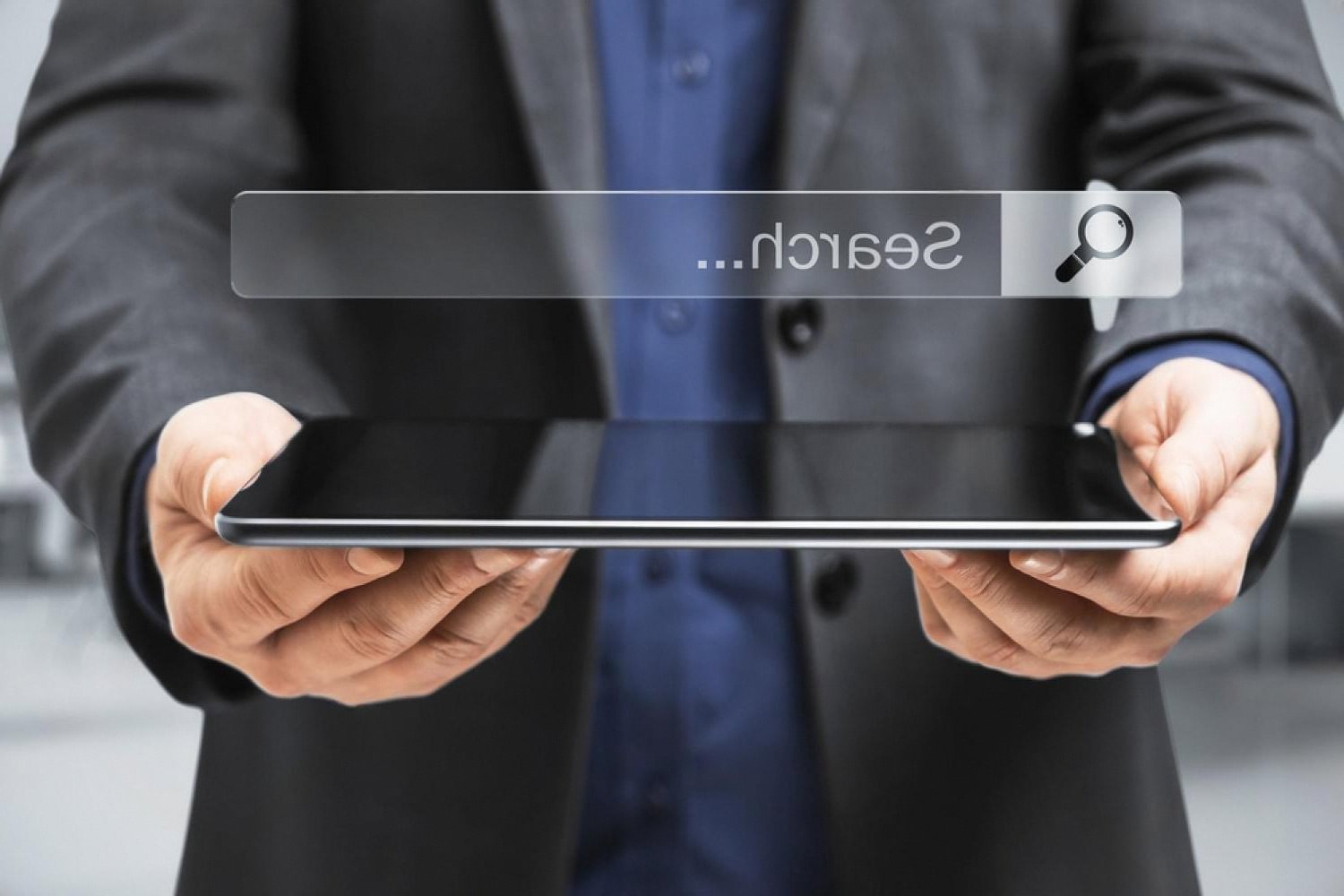 Businessman in the UAE holding a tablet with a search bar, researching a domain registration provider
